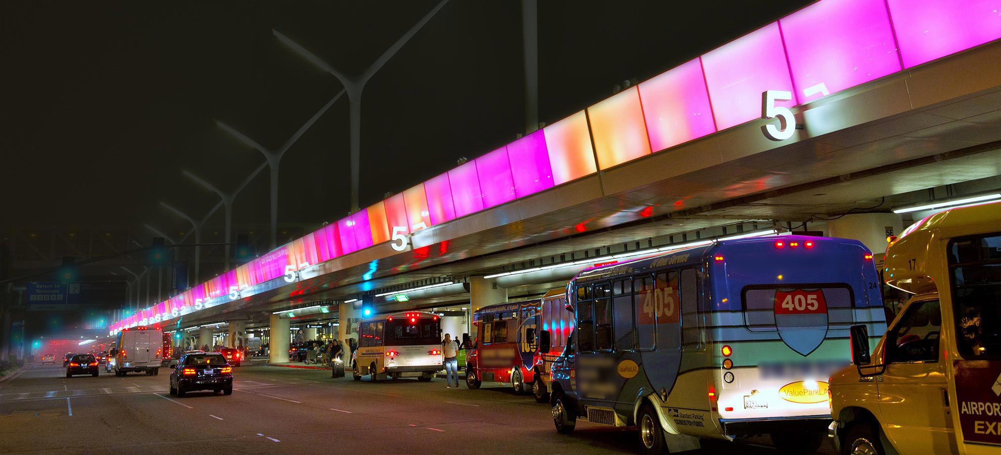 Terminals at LAX with cars parked out front.